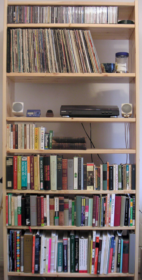 IKEA Tunhem Bookcase with books, records, a record player, speakers, and CDs stored on it