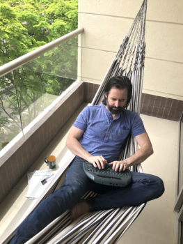 me writing in my hammock on a distraction-free writing device, the AlphaSmart